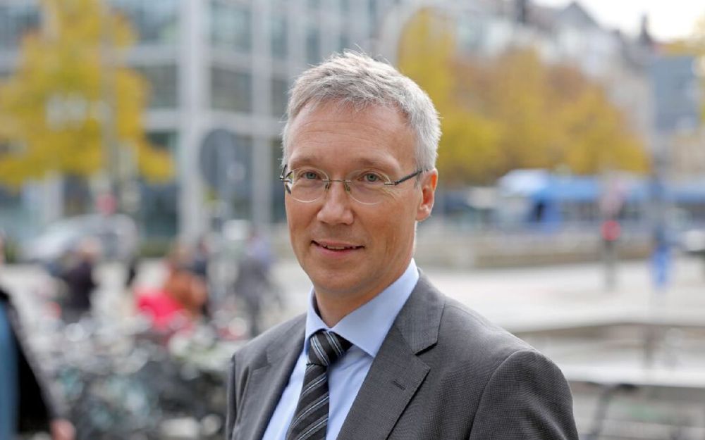 Das Bild zeigt den Münchner Mobilitätsreferenten Georg Dunkel im Porträt, einen weißen Mann mittleren Alters, mit kurzen grauen Haaren und Brille.