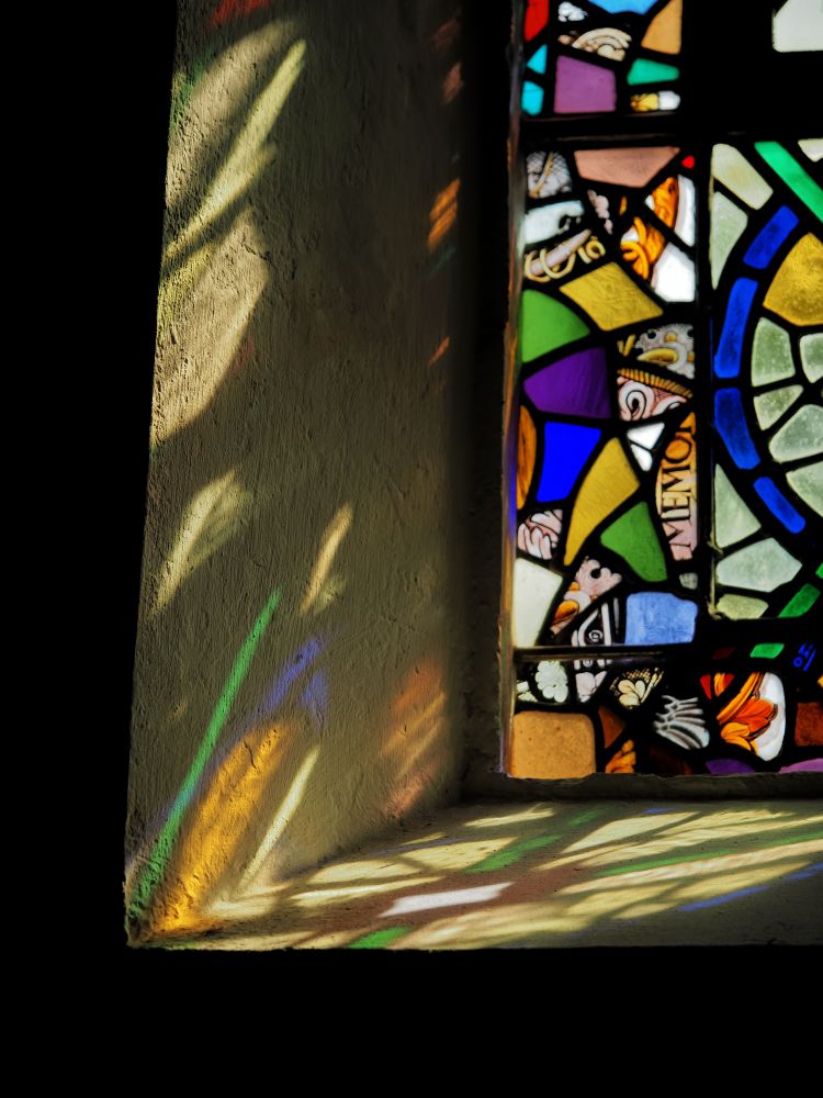 Coloured light and shadows from a stained glass window.