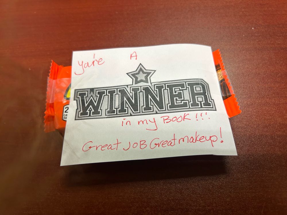 The only award I care about— full sized peanut butter cups with a cute note from Marge from Documents and “WINNER” printed on it with a star.