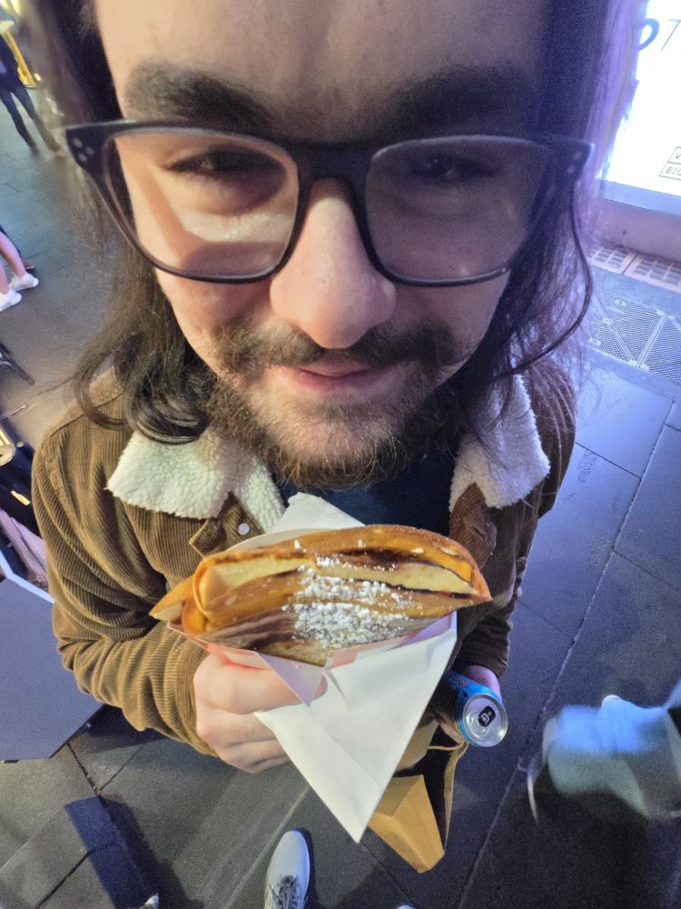 DoorMatt holding a crepe at a funny haha 0.5 zoom