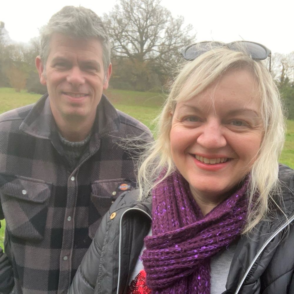 Adam and Jo standing in a park