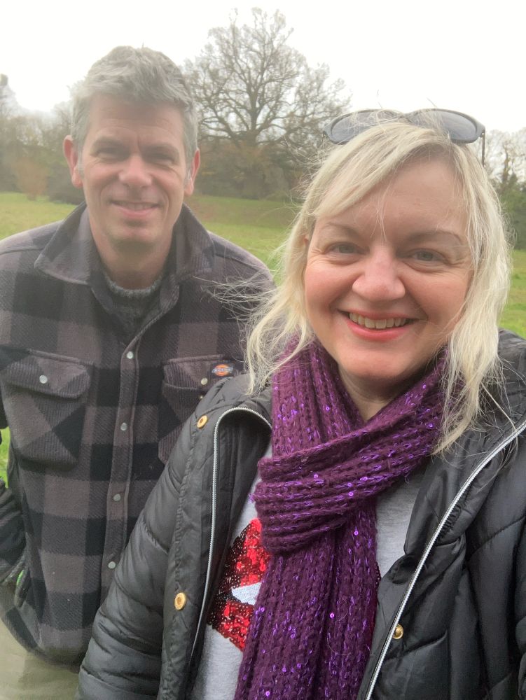 Adam and Jo standing in an arboretum 