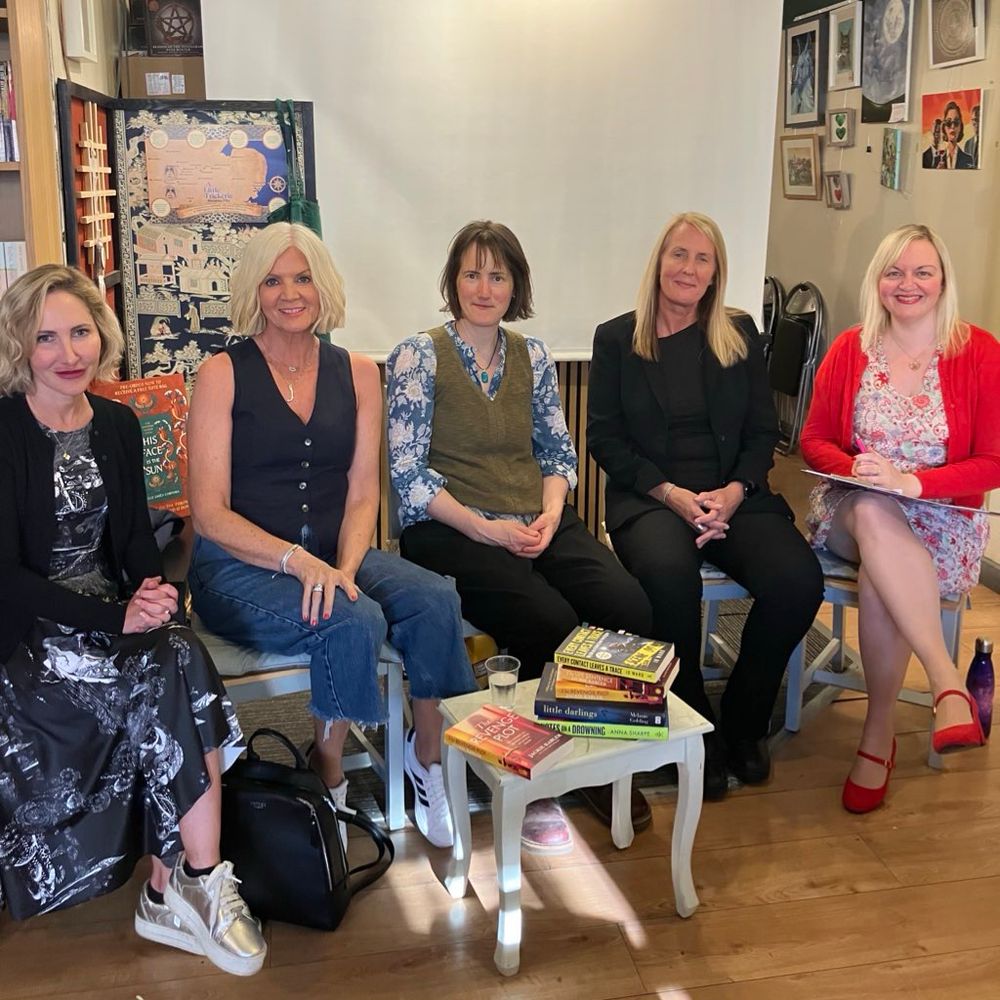 Anna, Jackie, Melanie, Jo and Jo sitting in the book shop 
