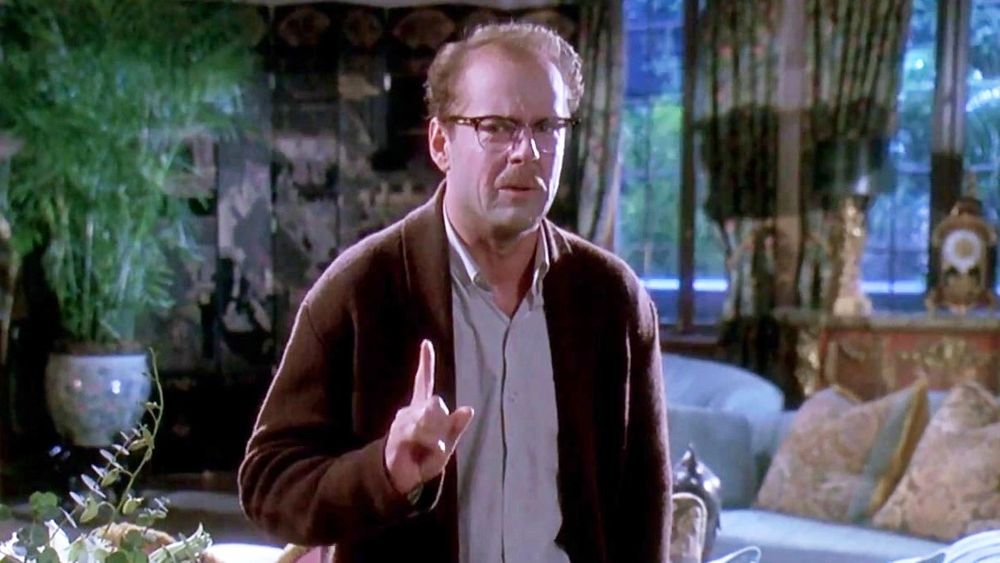 Bruce Willis in Death Becomes Her (1992). He's wearing a brown cardigan, nerd glasses, and looks distressed