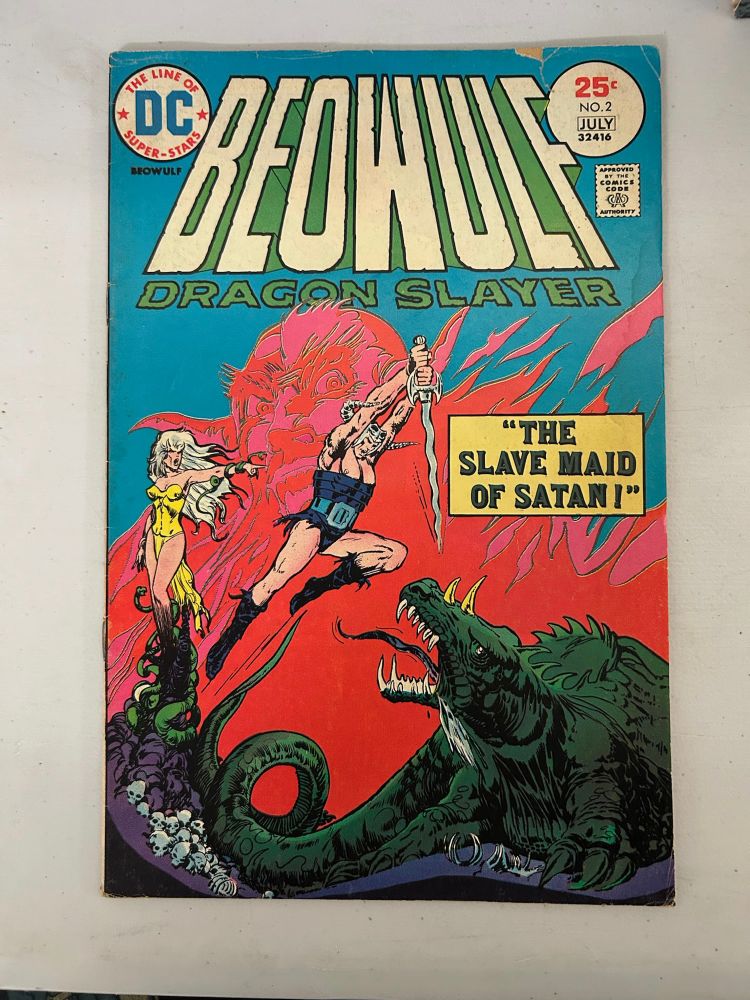 Beowulf Dragon Slayer #2 shows our protagonist jumping above a monster with sword ready to plunge into it. The caption reads, “The Slave Maid of Satan!”