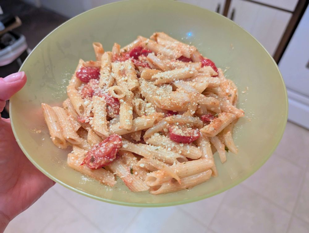fresh new pasta with sliced onions, grape tomatoes, olive oil, a few herbs, and parmesan