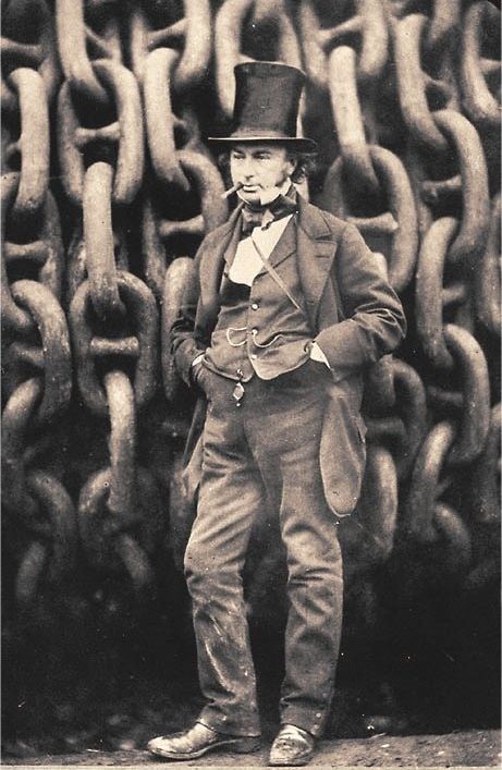 Man with stovepipe hat. Cigar in his mouth. In the background enormous anchor chains