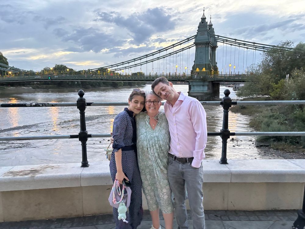 Pre dinner on a windy riverside terrace near Hammersmith Bridge. Ate a fabulous meal at Sam’s Riverside. Posing with my older son & his girlfriend getting dress & hair blown about. 