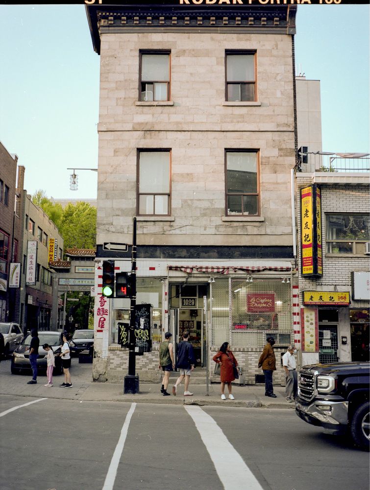 A building in Chinatown, Montreal Quebec. It’s of an intersection and the road is a slight hill.