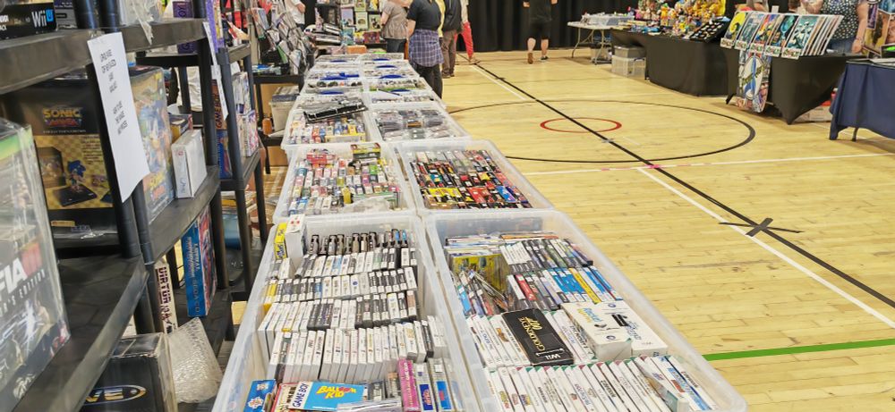 A photograph of lots of games in white plastic containers.