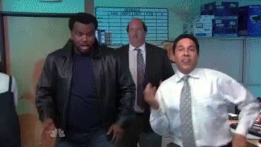 three men in suits and ties are dancing in a room .