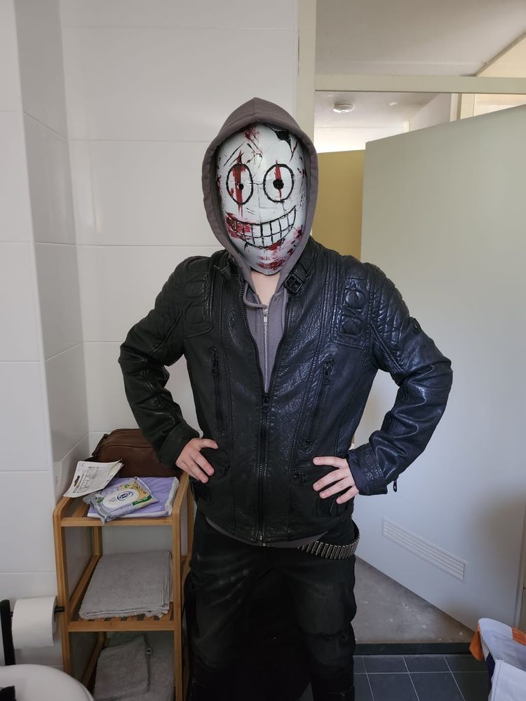 A picture of me cosplayed as legion (Frank) from Dead By Daylight. I'm posing in my bathroom, holding my hands on my hips.
