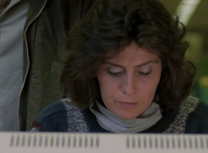 ChatGPT describes the image as "A woman with curly brown hair sits in front of a computer screen, intently focused on her work. She wears a knitted sweater with a blue, grey, and white pattern and a light-colored scarf. The lighting suggests an indoor, possibly office or laboratory environment, with blurred figures and equipment visible in the background. Her expression is serious and concentrated, likely reflecting a moment of investigation or critical discovery, typical of a tense, investigative drama setting."

BotOfDarkness, version 2.0.23. AWS Lambda version: 1.14.
