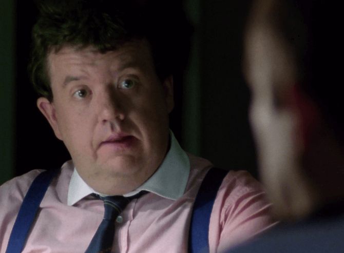 ChatGPT describes the image as "A man dressed in a pale pink shirt, dark tie, and blue suspenders sits in what appears to be a dimly lit office or meeting room. His expression suggests concern or surprise as he listens or reacts to another character, whose blurred profile is partially visible in the foreground. The scene’s subdued lighting and serious mood hint at a tense conversation or important disclosure, characteristic of investigative or political drama settings."

BotOfDarkness, version 2.0.23. AWS Lambda version: 1.14.
