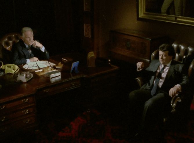 ChatGPT describes the image as "In this scene, two men are positioned in a dimly lit, traditional office setting characterized by dark wooden furniture and leather chairs. The man on the left sits behind a large desk cluttered with documents, phones, and a pair of glasses, suggesting he holds a position of authority or power. His contemplative posture, with hand resting near his mouth, indicates he is deep in thought, possibly weighing serious matters. The other man, seated more casually in a leather armchair to the right, appears tense or uneasy, his body language suggesting discomfort or submission. The atmosphere is heavy, evoking a sense of confrontation or an intense conversation likely tied to political or corporate intrigue."

BotOfDarkness, version 2.0.23. AWS Lambda version: 1.14.