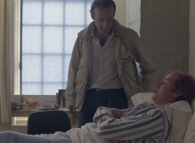 ChatGPT describes the image as "The image depicts an intense and intimate scene between two men in a modest, softly lit room. One man is lying in a bed, wearing striped pajamas, looking up at the other who stands beside him, dressed casually in a light jacket and shirt. The standing man’s posture suggests concern or urgency as he leans slightly forward, engaging the bedridden man, who appears weary or in distress. Behind them, a frosted window allows diffused light to fill the space, highlighting the somber atmosphere. The worn, simple furnishings and muted colors emphasize the gravity of the moment, suggesting a conversation revolving around vulnerability or critical information in a tense narrative context."

BotOfDarkness, version 2.0.23. AWS Lambda version: 1.14.