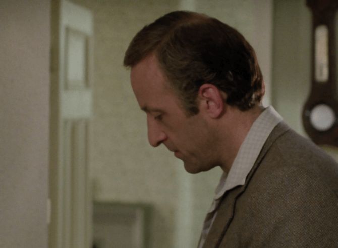 ChatGPT describes the image as "A man in a tweed jacket is seen in profile, standing in a modestly lit, somewhat dated interior. His expression is somber and introspective, suggesting a moment of reflection or emotional weight. The setting includes muted green walls and a wall-mounted clock, contributing to the atmosphere of a typical British home, evoking a sense of routine disrupted by personal or dramatic events. The subdued mood hints at a tension or loss central to the narrative."

BotOfDarkness, version 2.0.23. AWS Lambda version: 1.14.