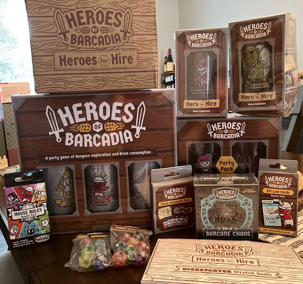 A photo of my delivered pledge from the Heroes of Barcadia: Heroes for Hire Kickstarter campaign. My pledge included: the Heroes of Barcadia base game, the Party Pack, the Classic Kickstarter Pack, the Heroes for Hire Expansion Pack, Hero for Hire Voodoo Ranger, Hero for Hire Brewtus the Barkeep, DIY Loot Card booster pack, DIY House Rules booster pack, Die of Barcane Chaos, and enhanced sparkle dice!