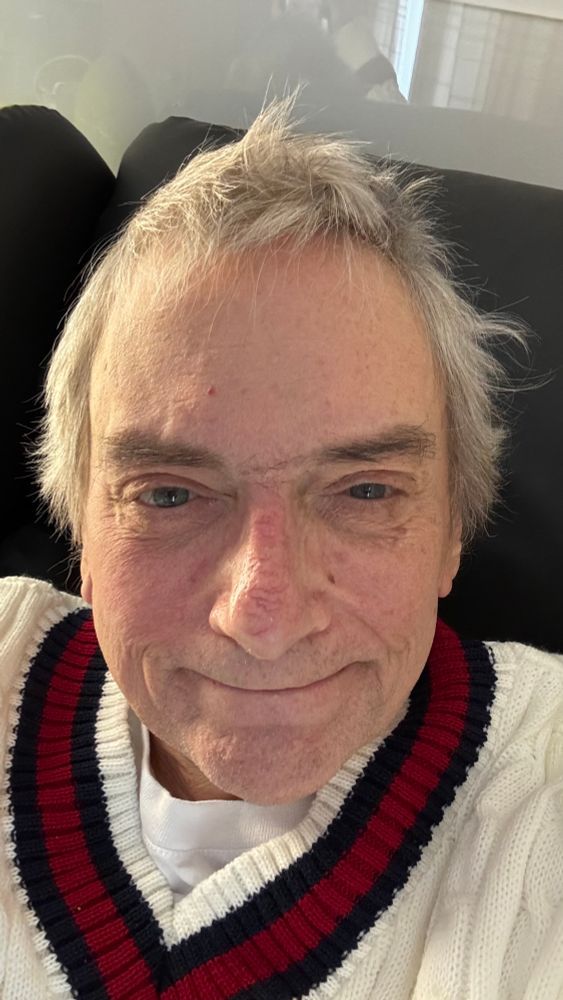 The author in a cosy, but unseasonal-looking cricket jumper 