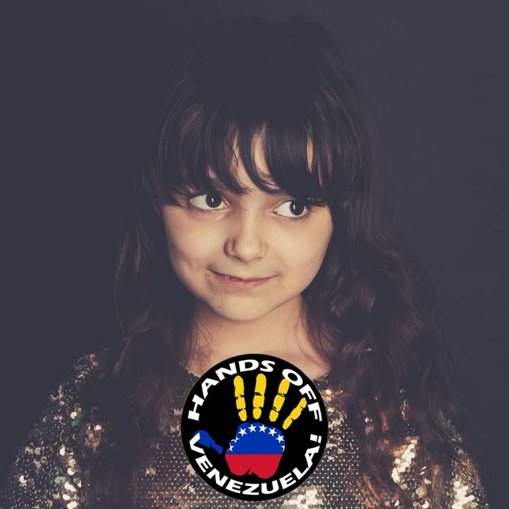 Photo of my daughter at 7 with a hands off Venezuela sticker 