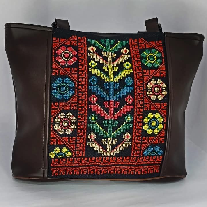 Photo of a black bag with tatreez embroidery on it
