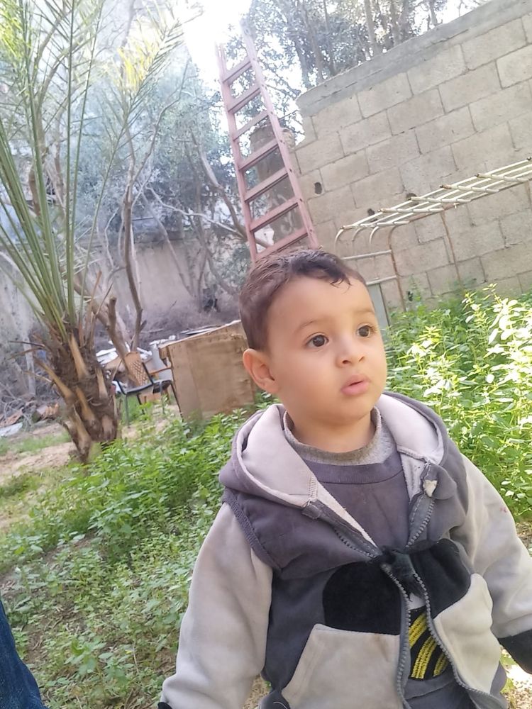 Photo of a sweet little two year-old boy outside