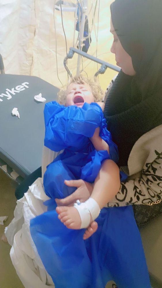 Sweet baby crying on mom’s lap 