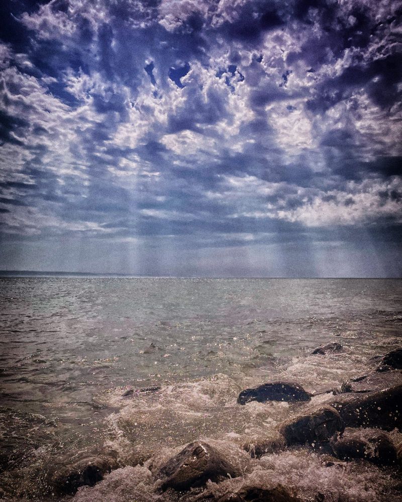 Sun rays and big clouds over the Severn and North Devon coast from Llantwit Major Beach