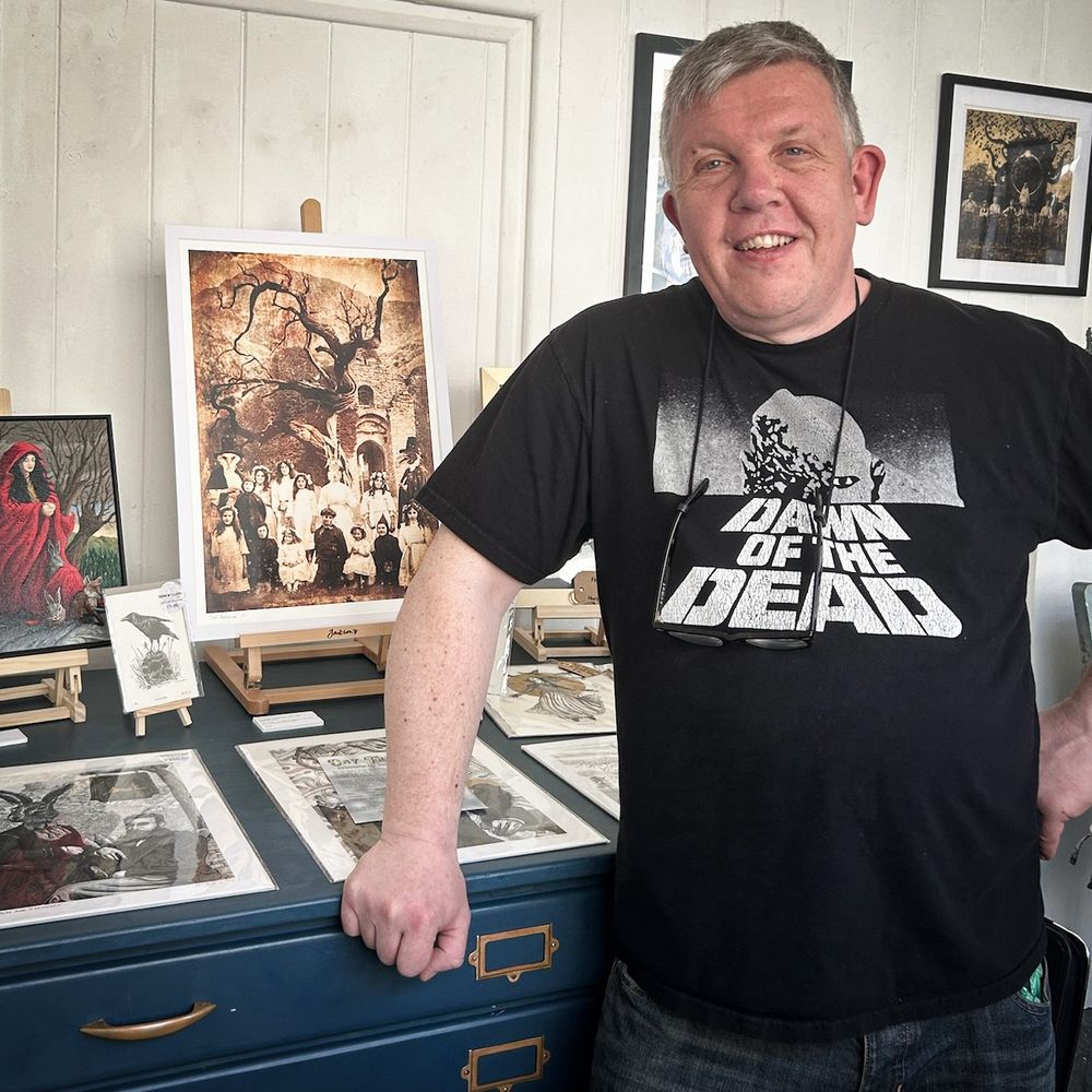 Photograph of Welsh artist David W. J. Lloyd in Oriel 6, Llantwit Major, showing off his work