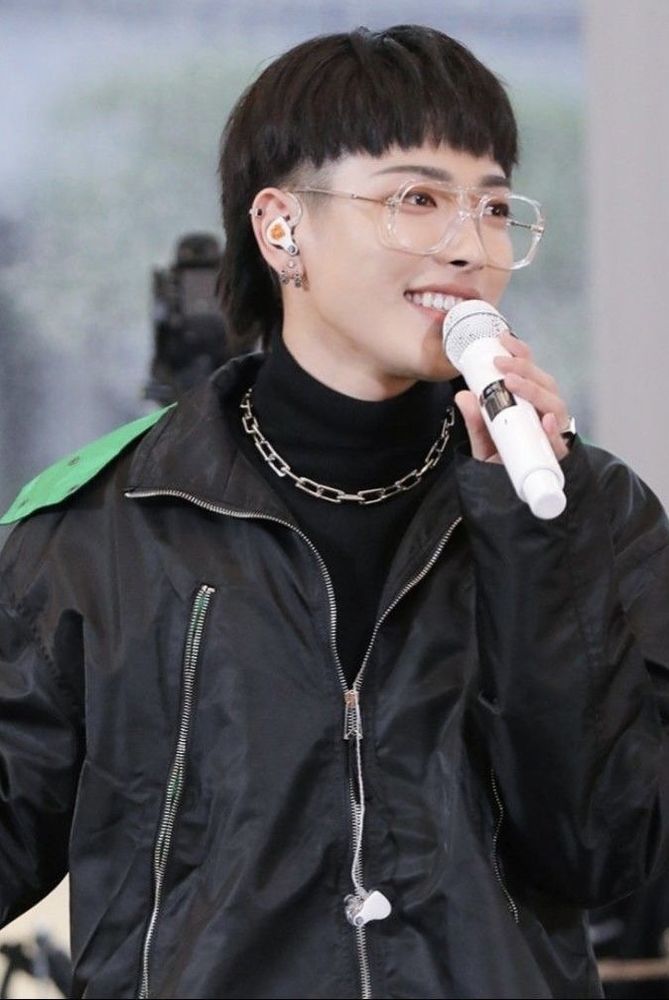 A picture of hongjoong with a black mullet hairstyle and short bangs