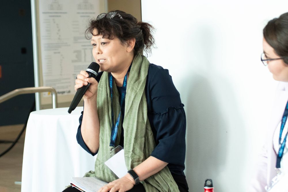 Rachel Gisselquist speaking into a microphone at the WIDER Development Conference in Helsinki, June 2025.