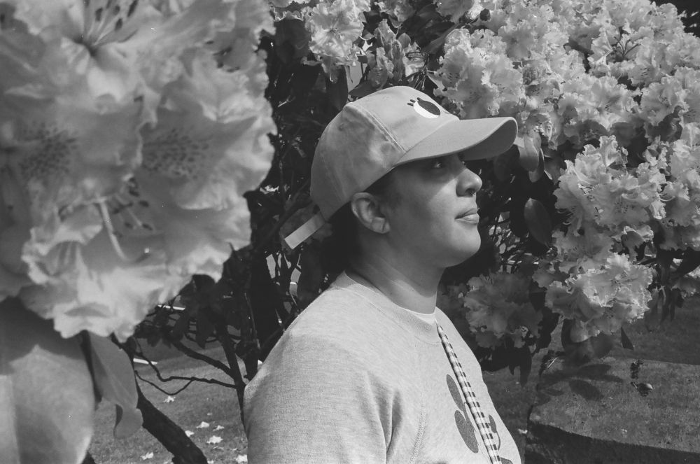A black and white photo the most beautiful woman you’ve ever seen among the flowers. 