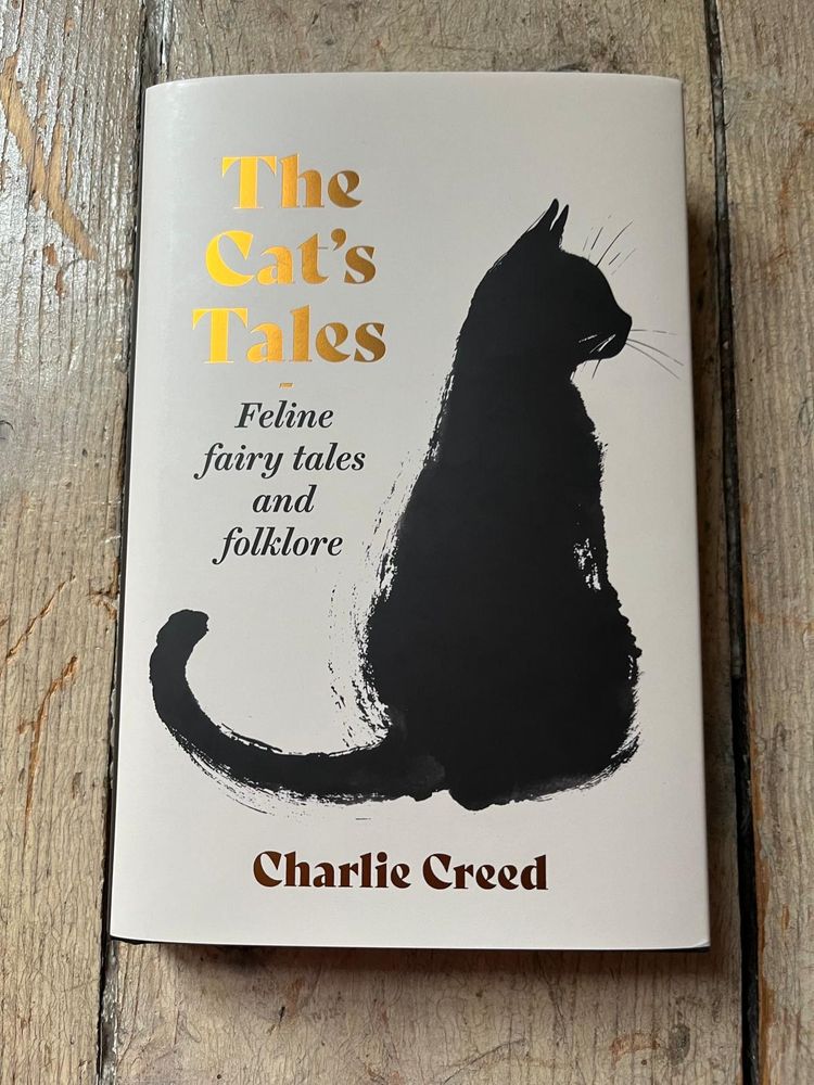 The Cat's Tales: Feline Fairy Tales and Folklore by Charlie Creed. An illustration of a black cat on a cream background.