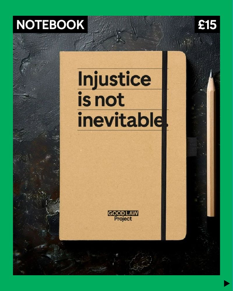 Notebook reading “Injustice is not inevitable”
