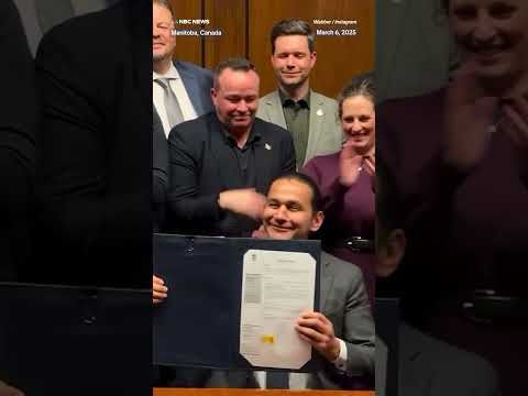 Manitoba Premier Wab Kinew signs an 'executive order' against U.S. liquor