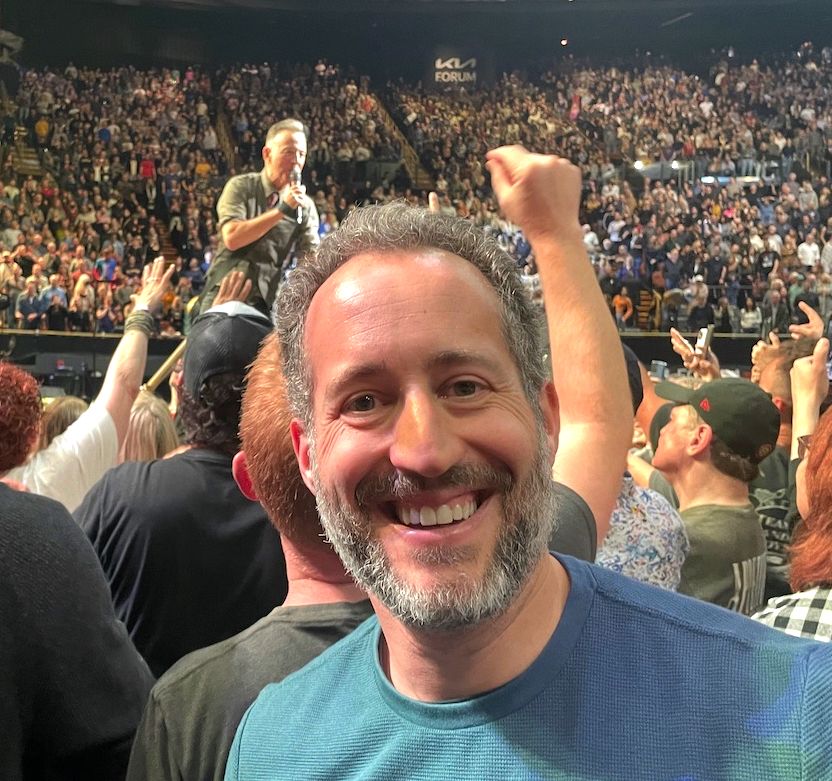 Kirk standing with Bruce Springsteen at his concert at the Kia Forum in LA in 2024.