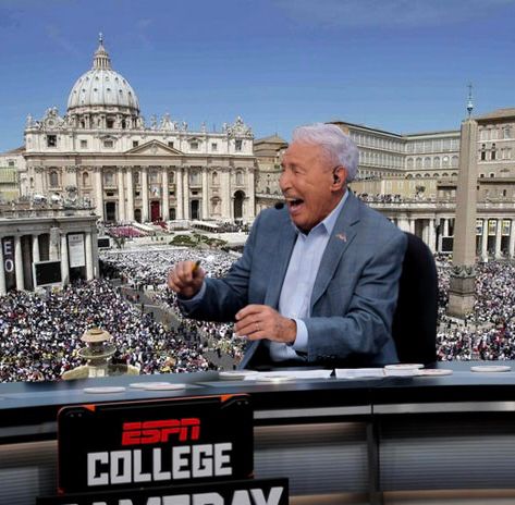 Lee Corso sitting at the College GameDay desk, with the Vatican crowd in the backgroind