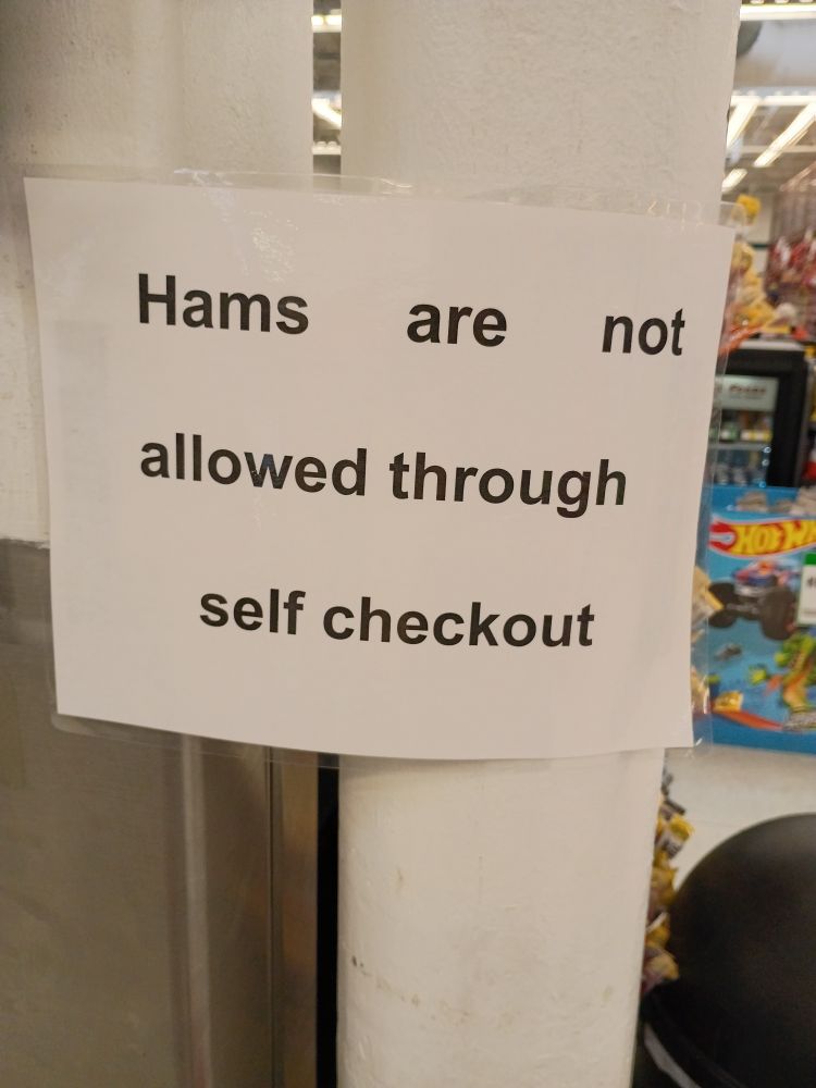 Sign at grocery store reading "Hams are not allowed through self checkout"