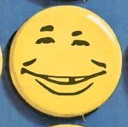 yellow button with silly alfred e neuman smile