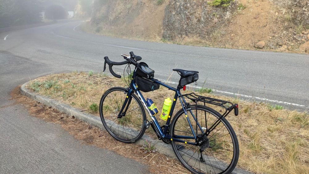 A bike with some fog and a tunnel in the distance.