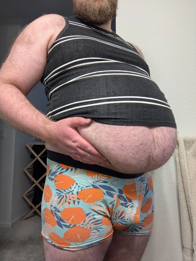 JP lifting their round, hairy, half-exposed belly