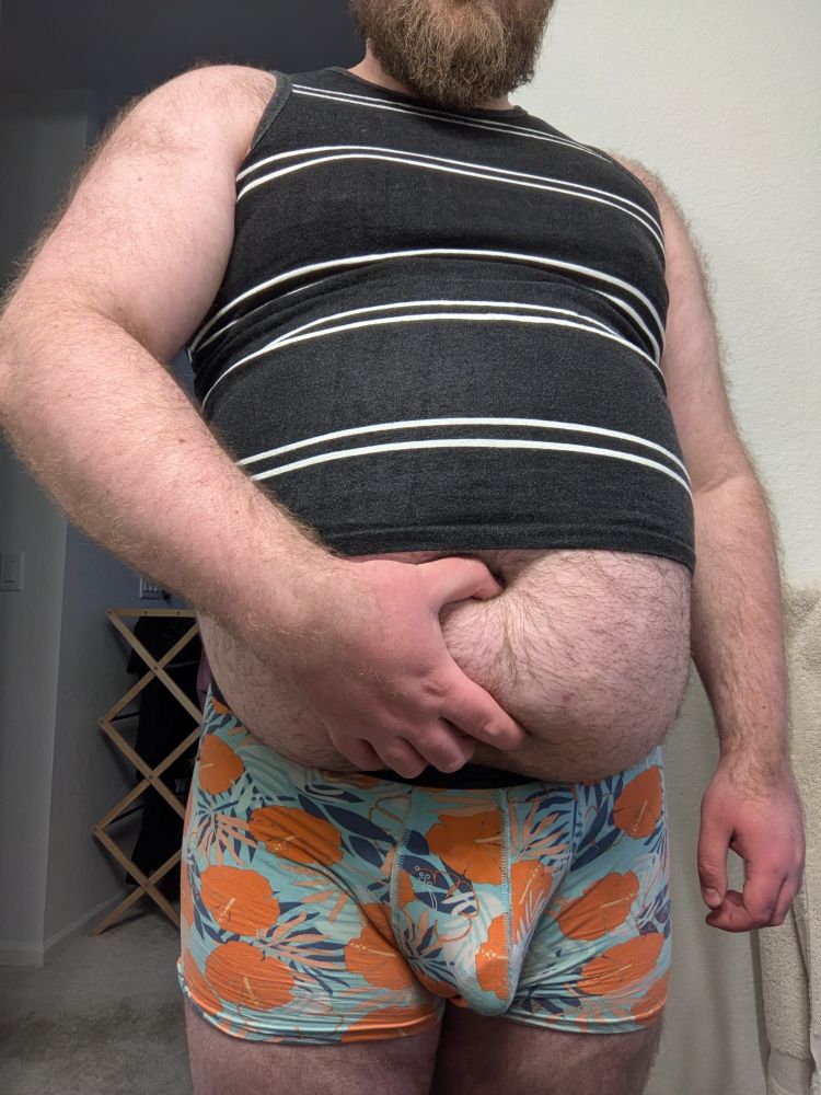 JP grabbing their round, hairy, half-exposed lower belly with one hand