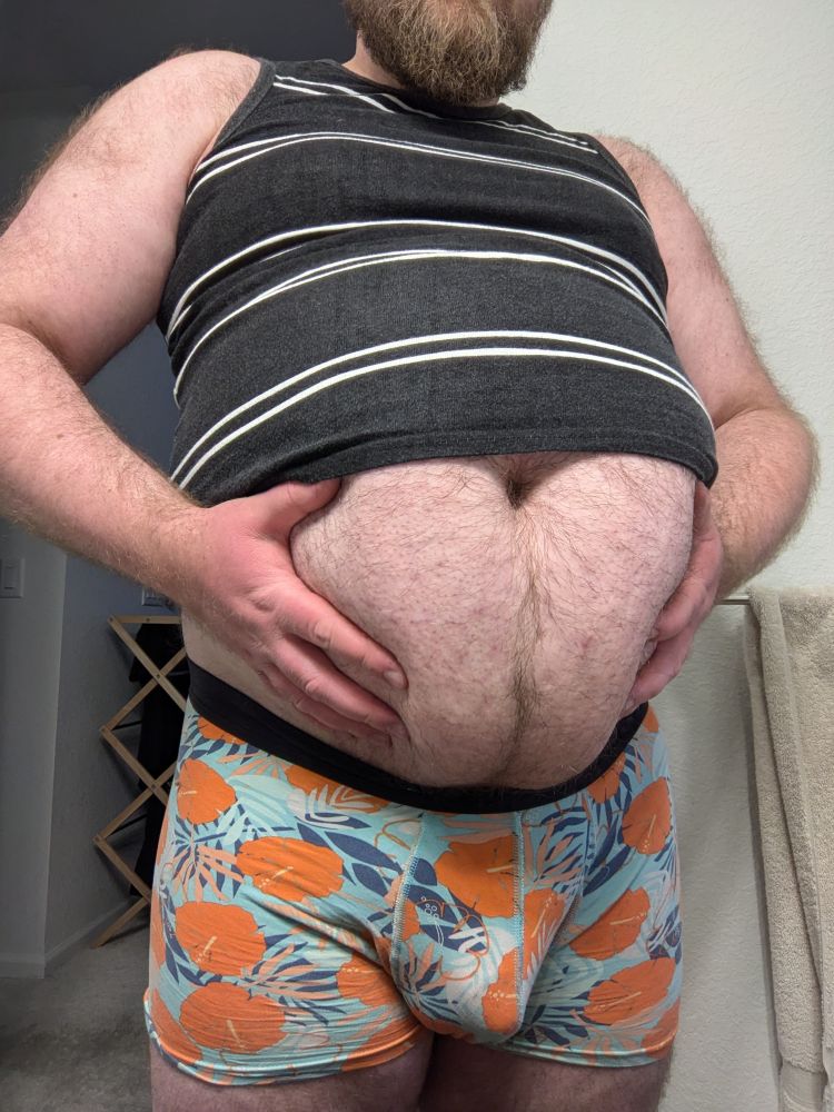 JP squeezing their round, hairy, half-exposed belly with both hands