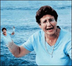 animated gif of an endless loop of zooming into a grandmother's hand to reveal it's the same grandmother, with a smaller grandmother for a hand, etc