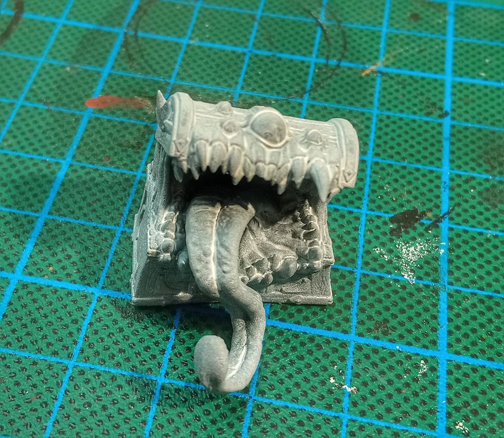 Horribly Bad zenithaled Mimic miniature with white paint where it absolutely should not be. 