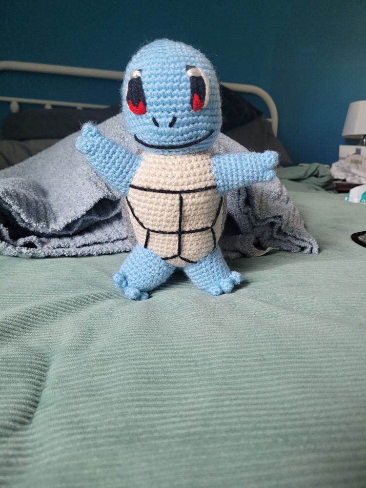 Front-view
A blue turtle with a light tan shell on the front, dark grey on the back edge, and a brownish orange on the back part of the shell.  