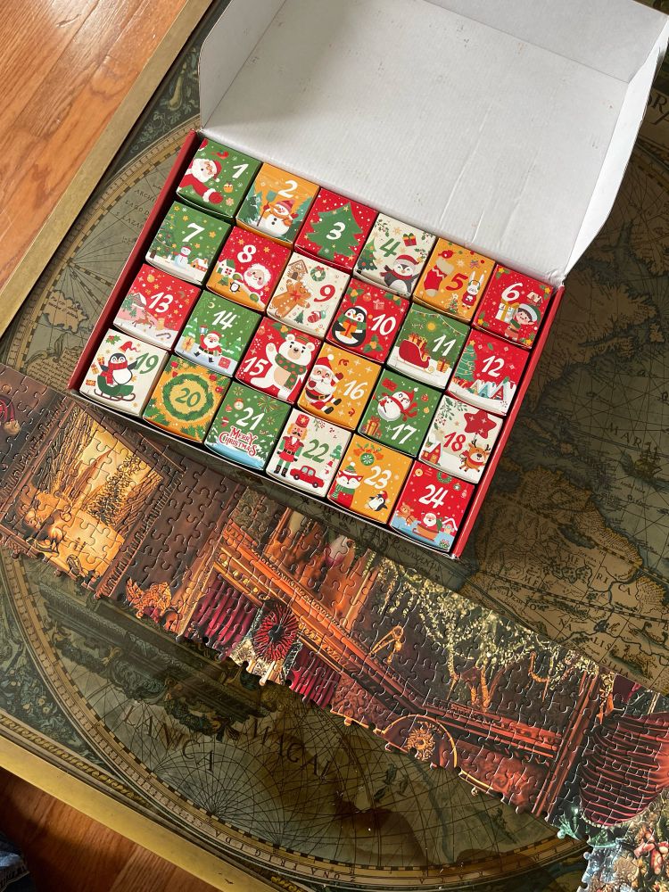 Christmas box with 24 smaller boxes of puzzle pieces for a December advent calendar 