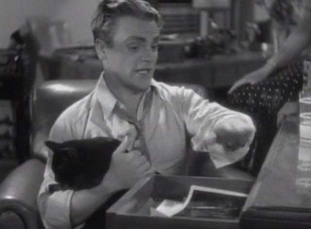 James Cagney holding a black cat 