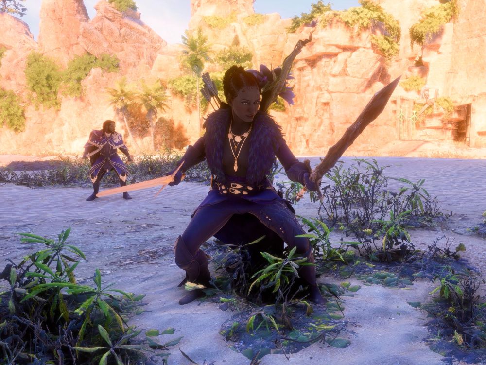 An animated screen shot of a red headed woman with her hair in braids wearing low cut feathered armor. She’s doing a dramatic pose while holding two swords. A bearded man standing in the background with matching armor. From the video game Dragon Age The Veilguard. 