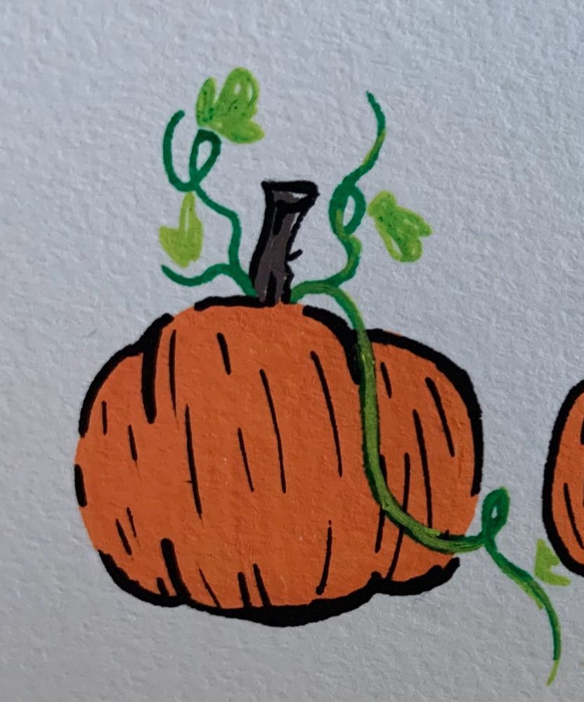 A zoomed in image of a pumpkin drawn with paint markers. 